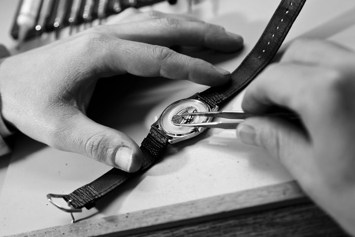 Servicing and Repairs - Watchmaker repairing a watch