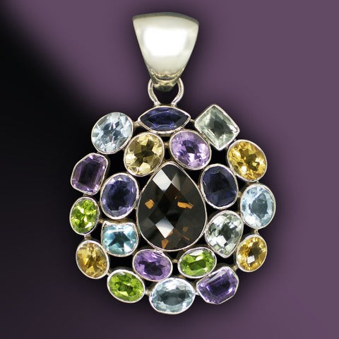 A picture of different gemstones making up the shape of a necklace pendant
