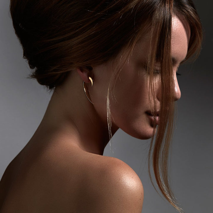 image of a model wearing a talon earring by shaun leane
