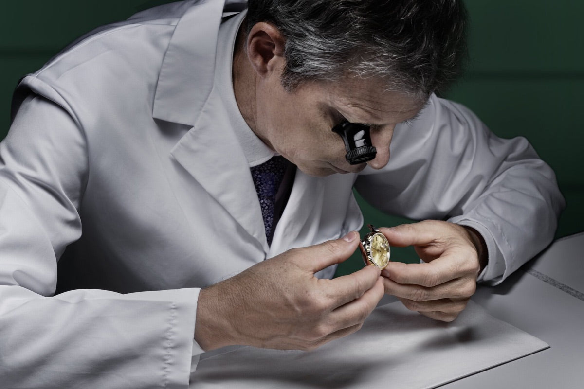 Watchmaker inspects a Rolex Watch case
