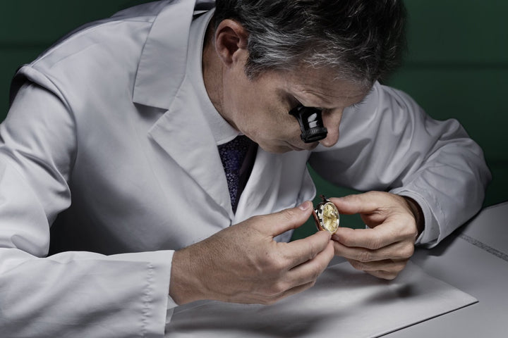 Watchmaker inspects a Rolex Watch case