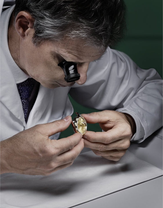 Rolex watchmaker inspects a case