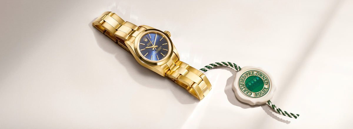 Rolex wristwatch with a close-up of the Rolex Certified Pre-Owned swing tag