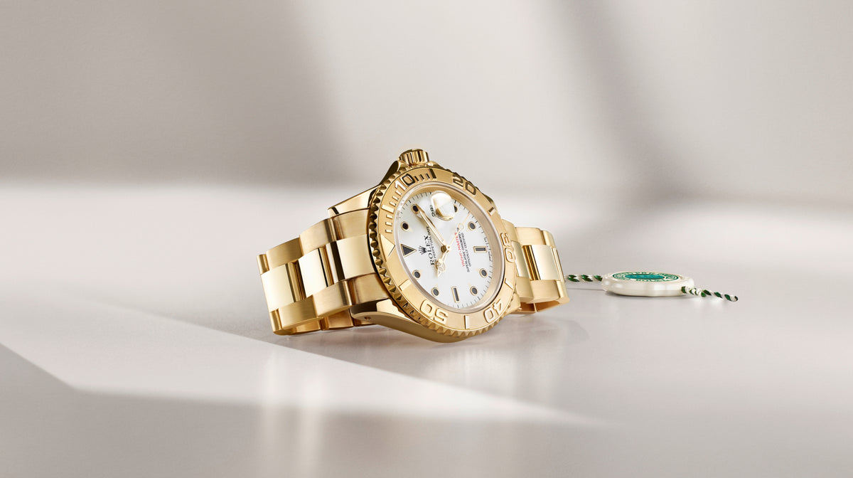 Rolex watch with a white face on a light grey background
