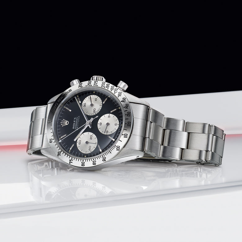 Rolex Silver watch with a black face on a white surface
