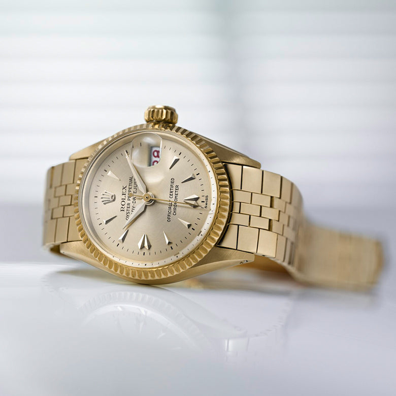 Rolex Gold wristwatch on a white background