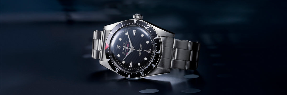 Rolex Milgauss wristwatch with a black face on a dark background