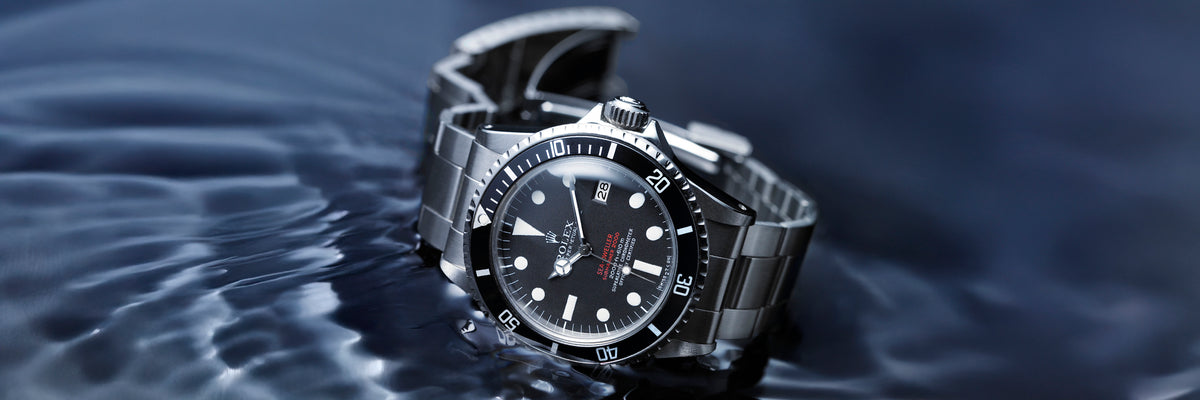 Rolex Sea-dweller watch with a black face on water