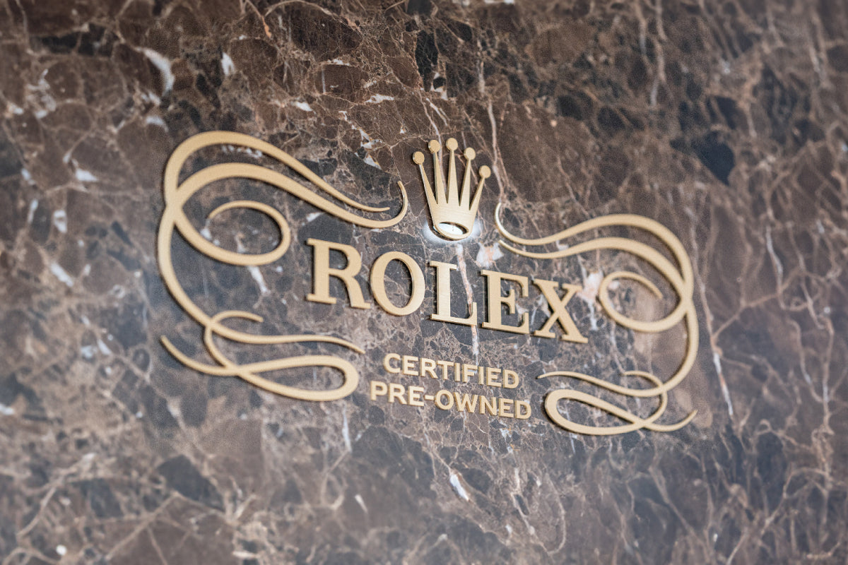 Rolex certified pre-owned logo on a marble surface