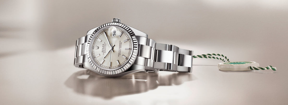 Rolex Datjust watch with a detailed face on a light background