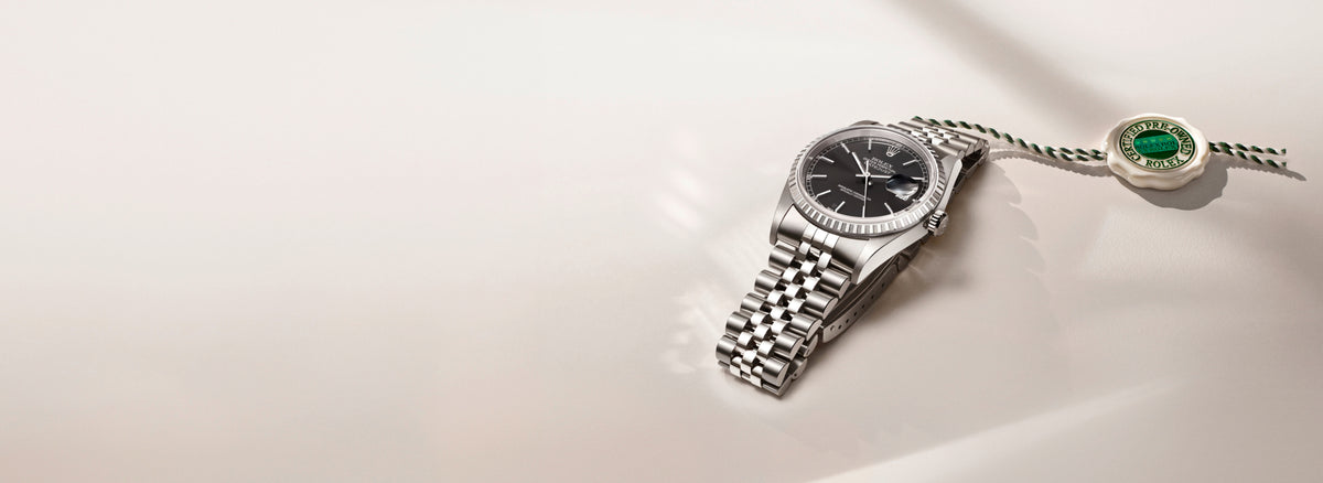 Rolex Silver watch with a detailed face on a light background