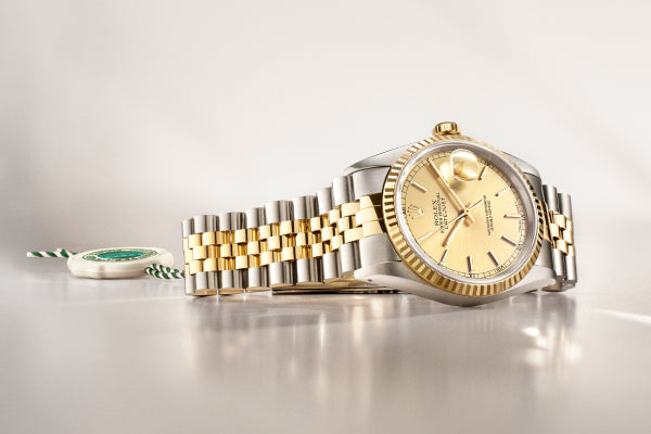 Rolex Gold and silver watch on a light grey background