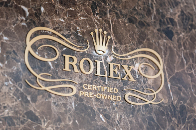 Rolex logo on a marbled surface