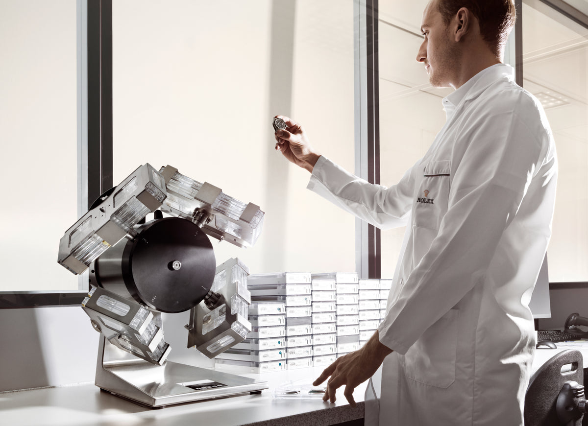 Person in a white lab coat interacting with a machine in a laboratory setting