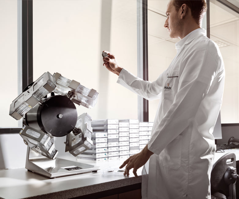 Person in a white lab coat using a machine in a laboratory setting